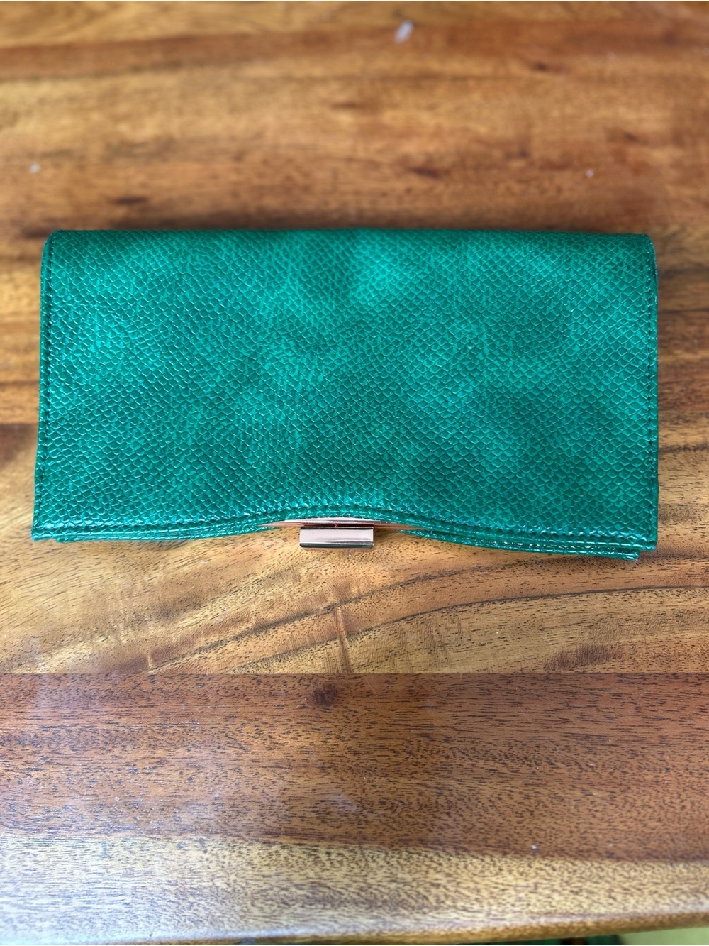 Dermstore Emerald Green Snakeskin Embossed Clutch. rose metal clasp top closure.